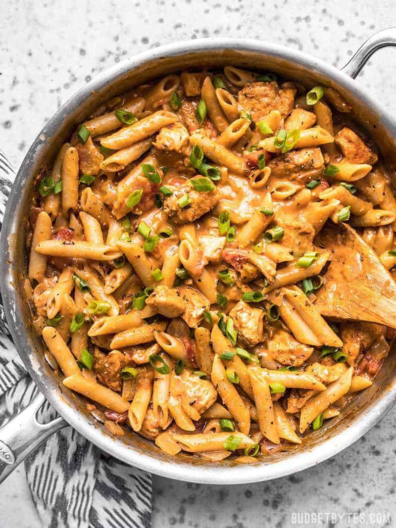 Cook a complete dinner in one pot with this Creamy Cajun Chicken Pasta, using mostly pantry-stable items. Perfect for busy weeknights! Budgetbytes.com One Pot Creamy Cajun Chicken Pasta ready to be served out of the pan.