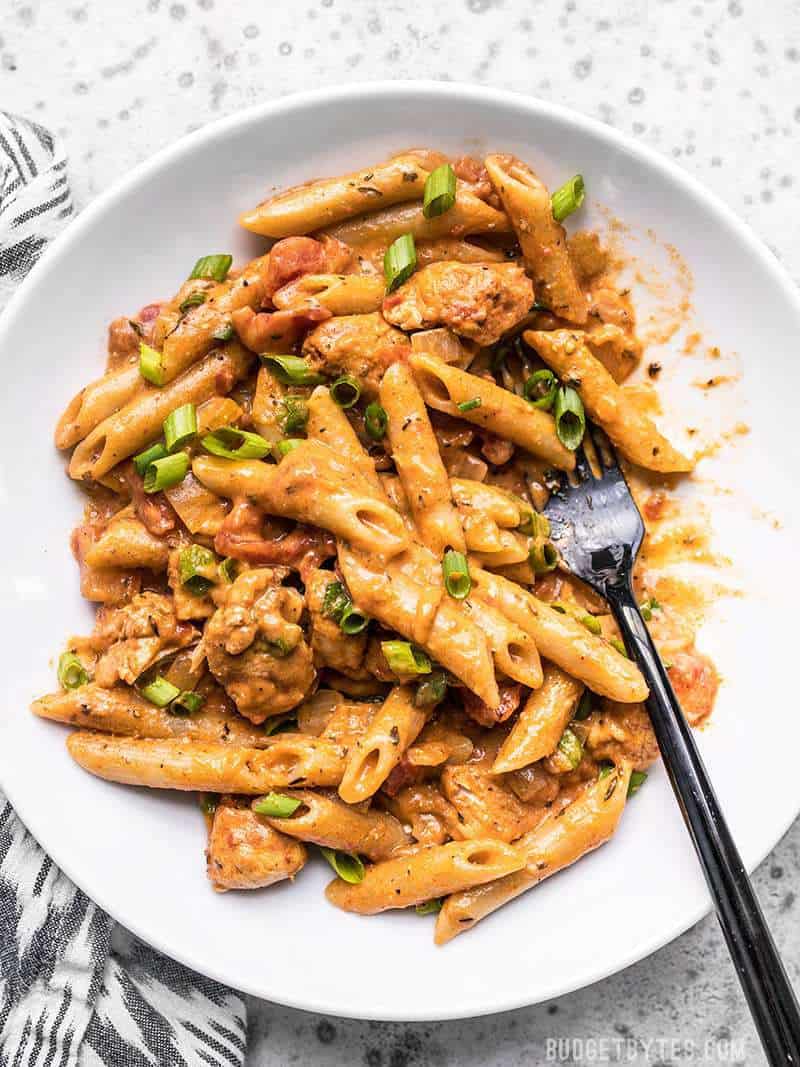 A bowl full of One Pot Creamy Cajun Chicken Pasta being eaten.
